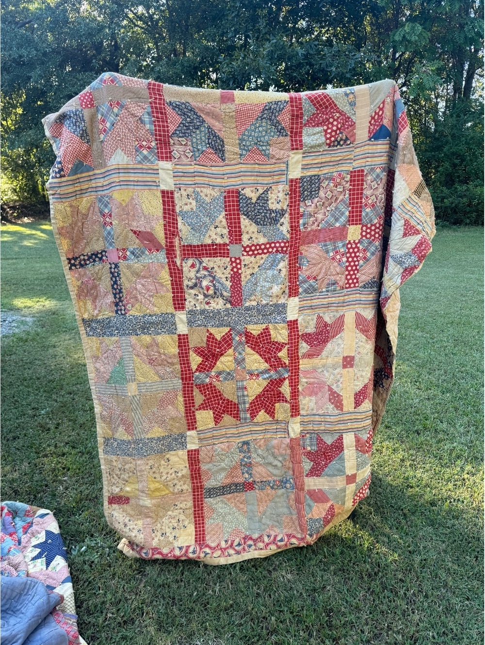 Vintage cutter patchwork quilt features a classic star block design